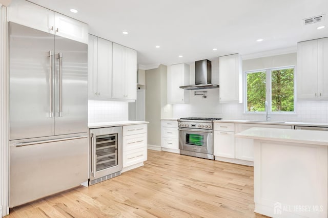 737 Wingate Dr, Bridgewater, NJ 08807 - kitchen featuring high quality appliances, beverage cooler, wall chimney exhaust hood, light countertops, and recessed lighting
