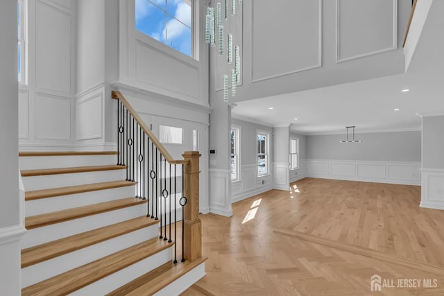 737 Wingate Dr, Bridgewater, NJ 08807 - entryway featuring a decorative wall, crown molding, plenty of natural light, stairway, and a wainscoted wall