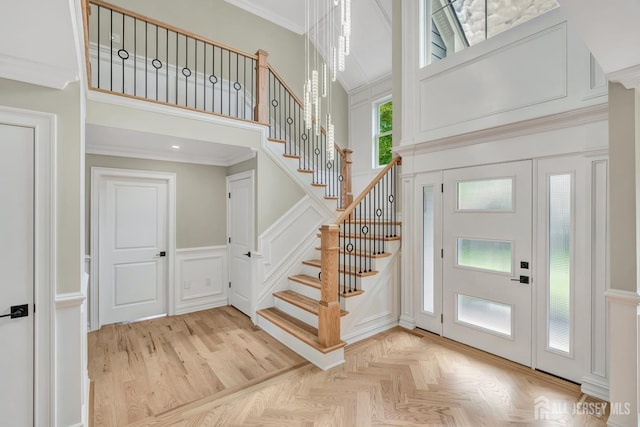 737 Wingate Dr, Bridgewater, NJ 08807 - entryway featuring a decorative wall, stairs, ornamental molding, a towering ceiling, and a wainscoted wall