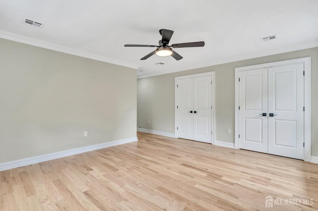 737 Wingate Dr, Bridgewater, NJ 08807 - unfurnished bedroom with multiple closets, light wood finished floors, crown molding, and ceiling fan