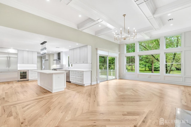 737 Wingate Dr, Bridgewater, NJ 08807 - unfurnished living room featuring beverage cooler, a chandelier, a towering ceiling, beam ceiling, and recessed lighting