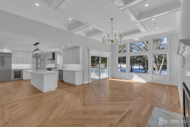 737 Wingate Dr, Bridgewater, NJ 08807 - kitchen with wine cooler, a chandelier, dishwasher, wall chimney range hood, and a high ceiling