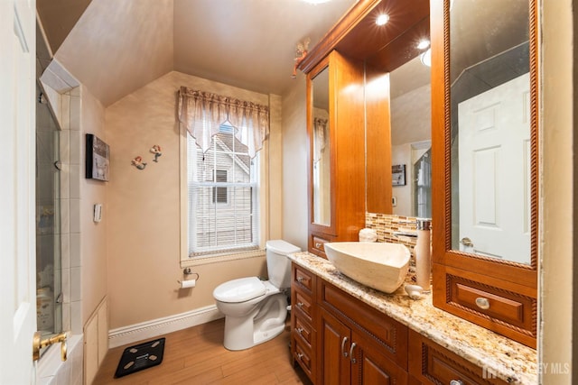 545 Myrtle Ave, Woodbridge Proper, NJ 07095 - bathroom featuring wood finished floors, vanity, vaulted ceiling, and decorative backsplash