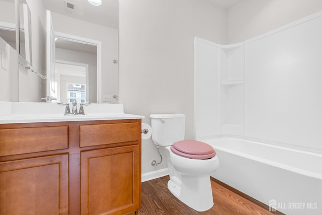 full bath featuring visible vents, baseboards, toilet, wood finished floors, and vanity