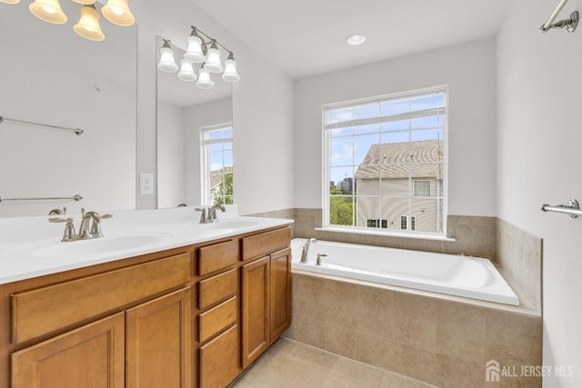 full bath featuring a garden tub, double vanity, a sink, and tile patterned floors