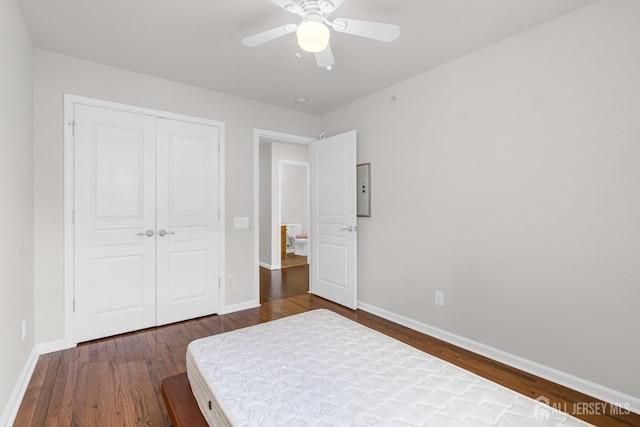 1202 Ella Ln, Highland Park, NJ 08904 - bedroom with dark wood finished floors, baseboards, a closet, and a ceiling fan