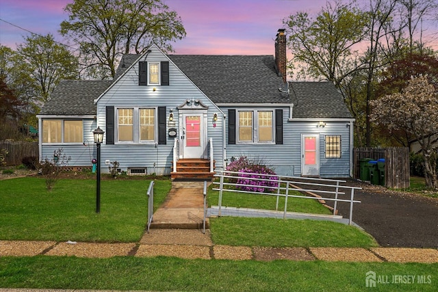 cape cod home featuring a chimney and roof with shingles