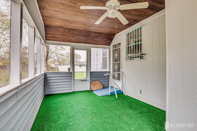 unfurnished sunroom featuring ceiling fan and vaulted ceiling