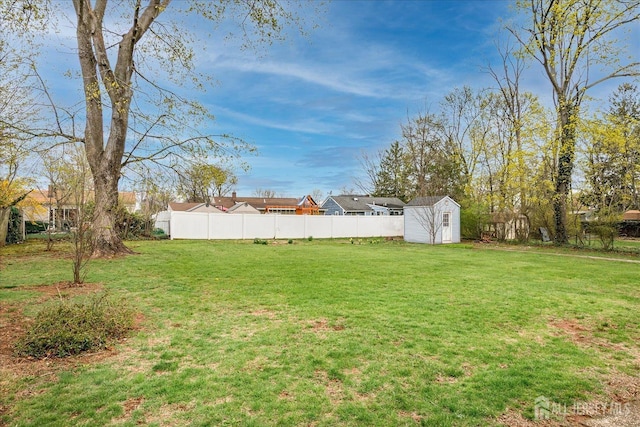 view of yard featuring a storage unit and an outbuilding