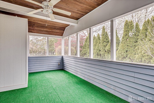 unfurnished sunroom featuring ceiling fan