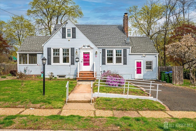 view of front of property featuring a chimney and roof with shingles