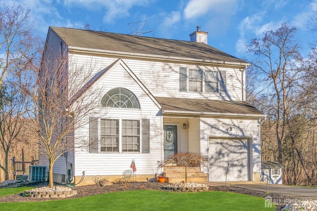 view of front of home with a front lawn, cooling unit, driveway, and a chimney