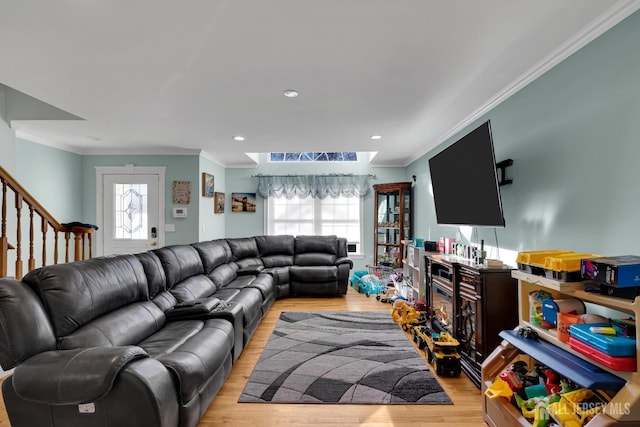 living room with stairway, recessed lighting, light wood-type flooring, and ornamental molding