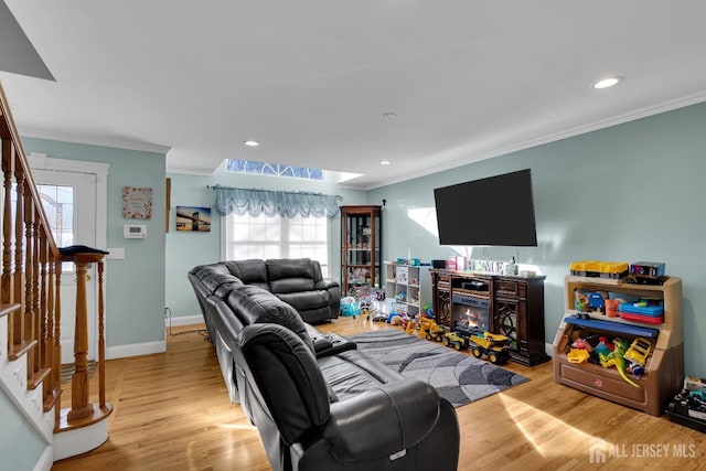 living area with stairway, wood finished floors, baseboards, recessed lighting, and ornamental molding