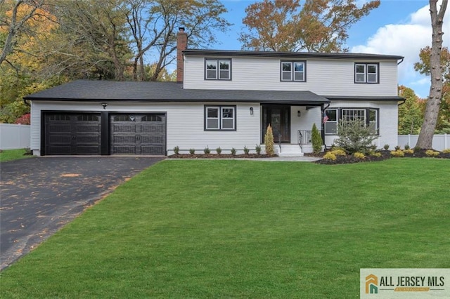 view of front property with a garage and a front lawn