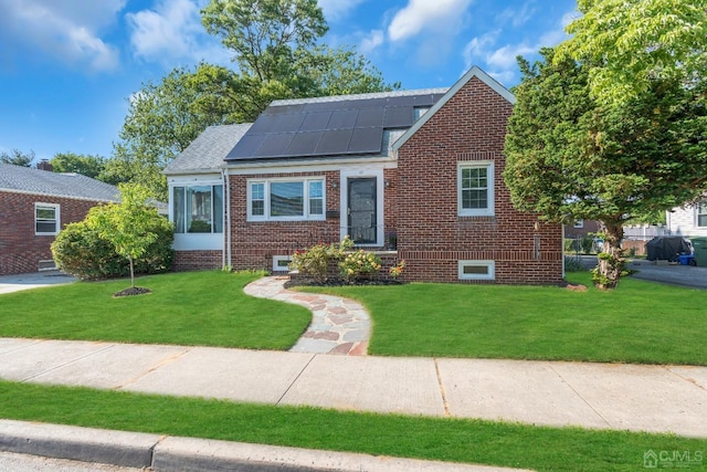 bungalow-style house with a front yard and solar panels