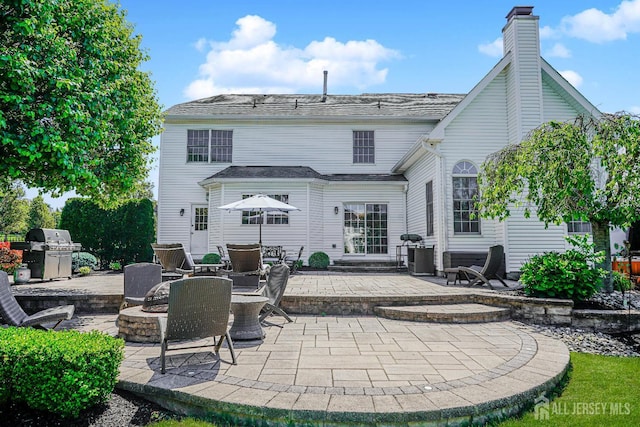 5 Bridle Ct, Monroe, NJ 08831 - rear view of house featuring a patio and a chimney