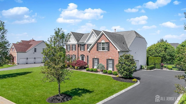 5 Bridle Ct, Monroe, NJ 08831 - view of front of home featuring brick siding, driveway, a garage, and a front yard