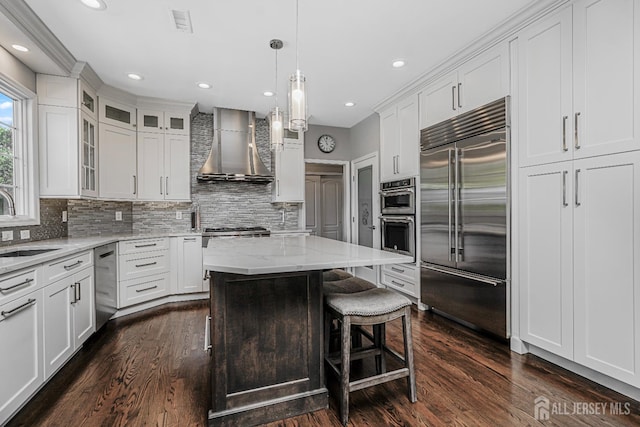 5 Bridle Ct, Monroe, NJ 08831 - kitchen featuring stainless steel appliances, wall chimney exhaust hood, white cabinets, tasteful backsplash, and recessed lighting