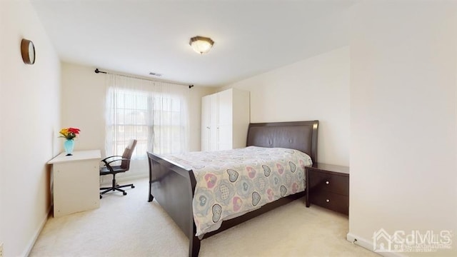 bedroom featuring light colored carpet