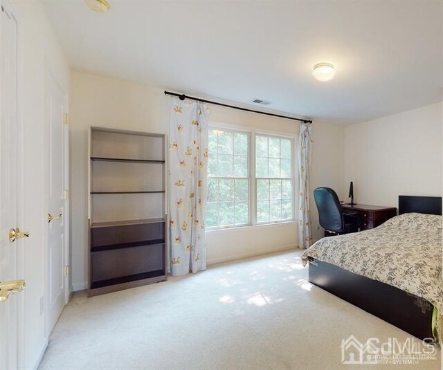 bedroom featuring light colored carpet