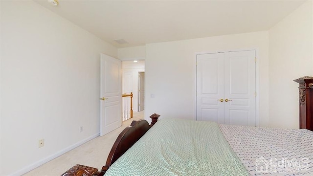 carpeted bedroom with a closet