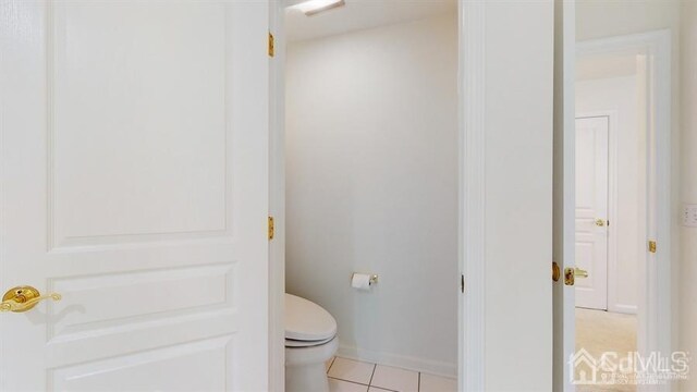 bathroom featuring toilet and tile patterned floors