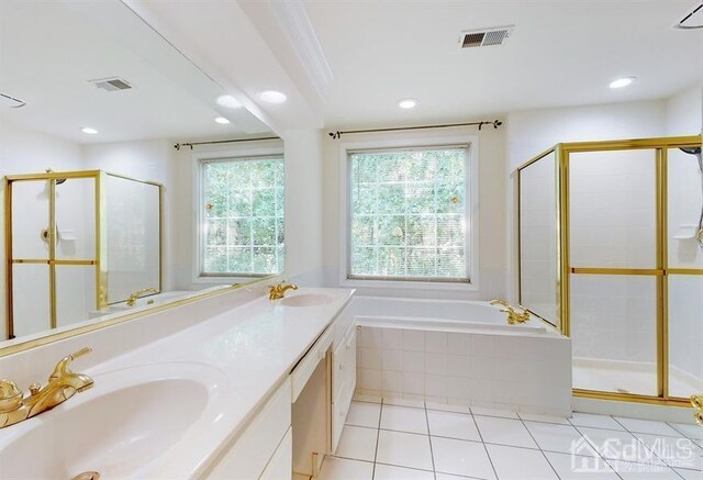 bathroom with separate shower and tub, vanity, and tile patterned floors