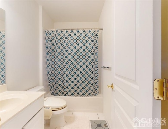 full bathroom featuring toilet, tile patterned flooring, vanity, and shower / tub combo with curtain