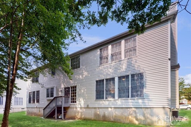 rear view of property featuring a yard