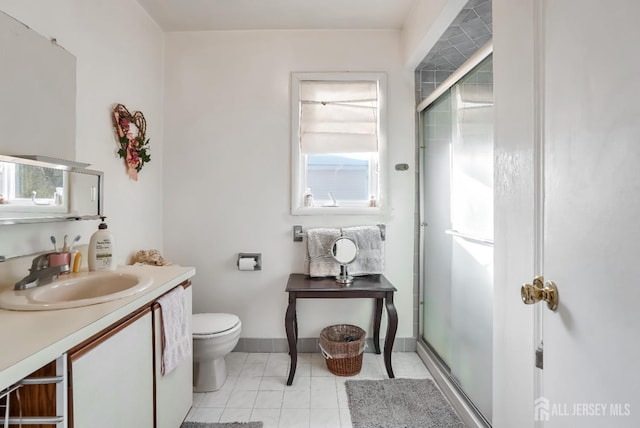 bathroom featuring an enclosed shower, vanity, tile patterned floors, and toilet