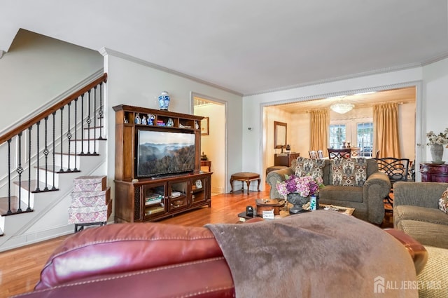 living room featuring wood-type flooring and ornamental molding