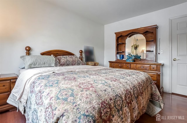 bedroom with dark wood-type flooring