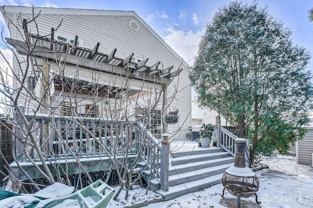 snow covered building featuring a fire pit