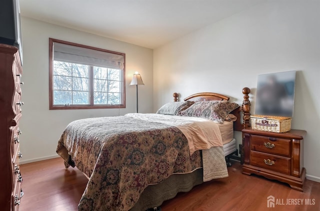 bedroom with dark wood-type flooring