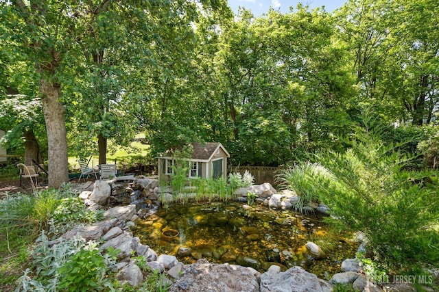 5 Meade Ct, Piscataway, NJ 08854 - view of yard featuring a storage shed and a small pond