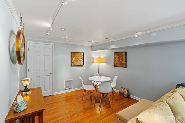 5 Meade Ct, Piscataway, NJ 08854 - dining area with rail lighting, wood finished floors, and ornamental molding