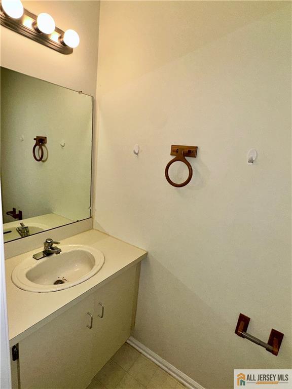 bathroom with vanity and baseboards