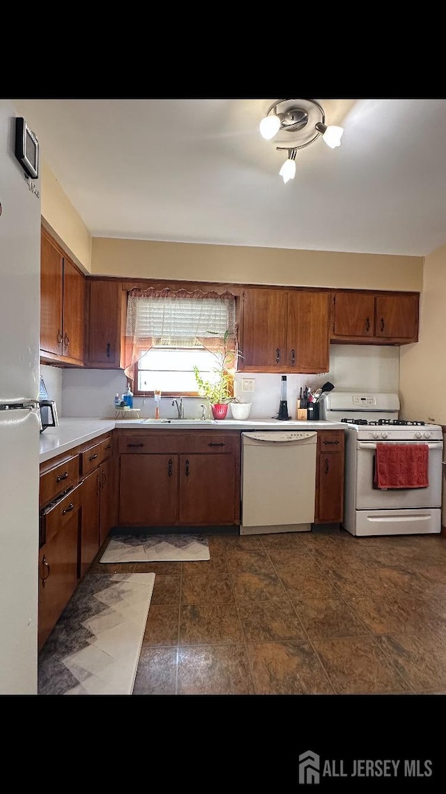 kitchen featuring sink and white appliances