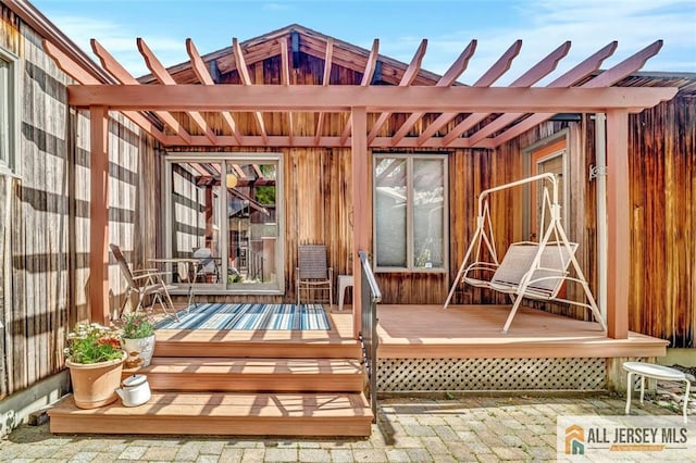 view of patio / terrace featuring a wooden deck and a pergola