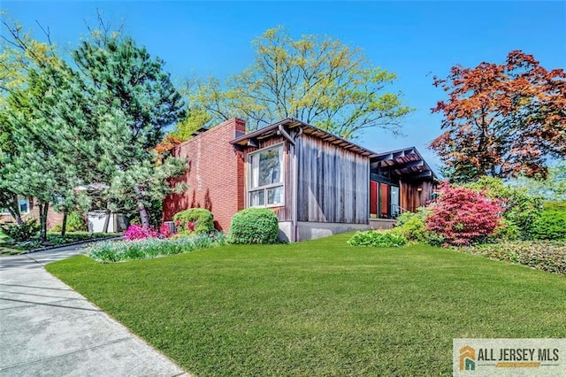 2 Snapper Ave, South River, NJ 08882 - view of property exterior featuring a yard, board and batten siding, and concrete driveway
