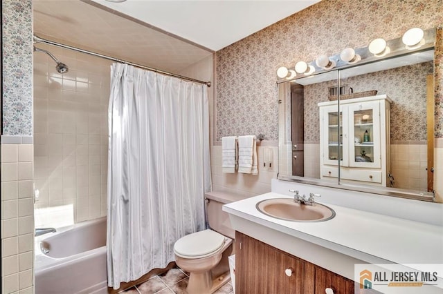 full bath featuring tile patterned flooring, vanity, toilet, wallpapered walls, and tile walls