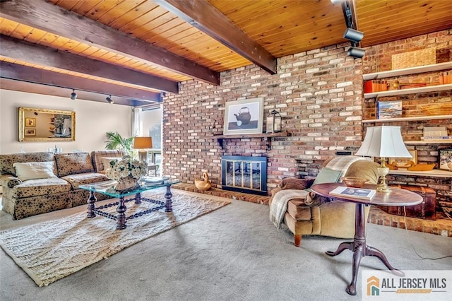 living room with a fireplace, brick wall, carpet, beamed ceiling, and wood ceiling