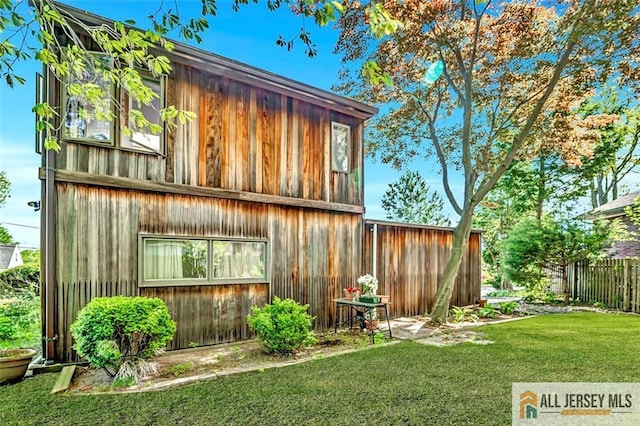 view of outbuilding with fence