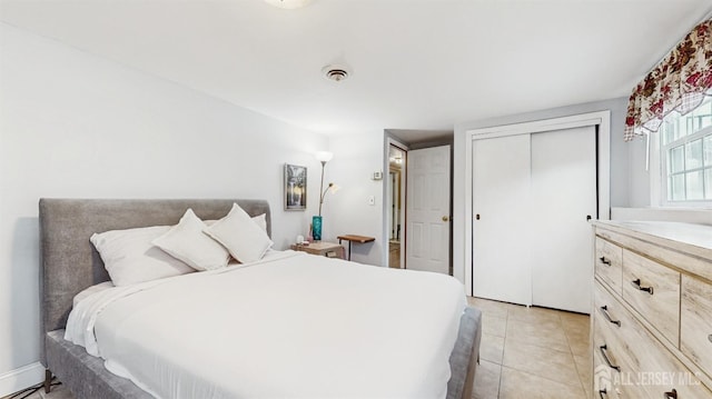 bedroom featuring light tile patterned flooring and a closet