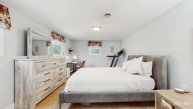 bedroom with light tile patterned floors