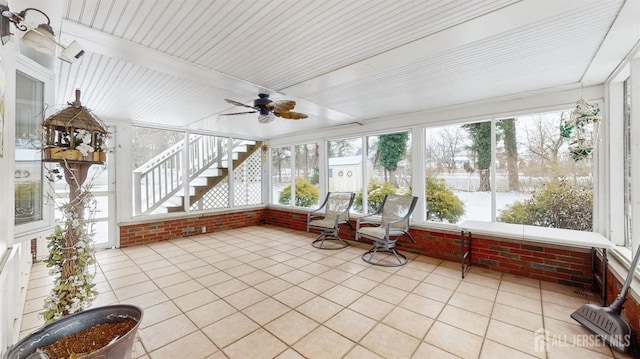 unfurnished sunroom with ceiling fan