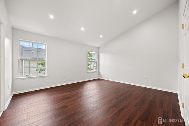 19 Grossweiler Ln, Parlin, NJ 08859 - unfurnished room with healthy amount of natural light, dark wood finished floors, vaulted ceiling, baseboards, and recessed lighting