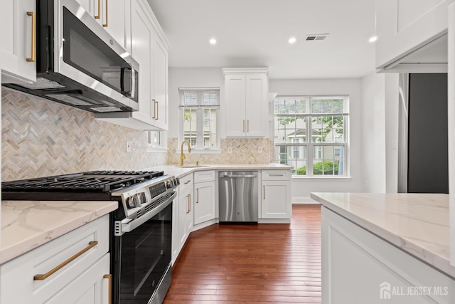 19 Grossweiler Ln, Parlin, NJ 08859 - kitchen with appliances with stainless steel finishes, dark wood-style flooring, recessed lighting, white cabinetry, and decorative backsplash