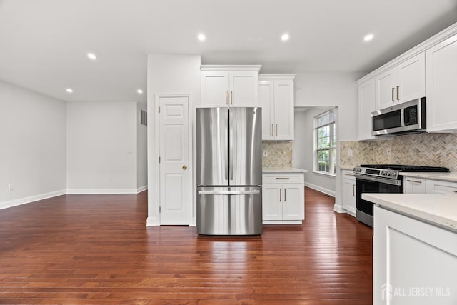 19 Grossweiler Ln, Parlin, NJ 08859 - kitchen with stainless steel appliances, recessed lighting, decorative backsplash, white cabinets, and dark wood finished floors